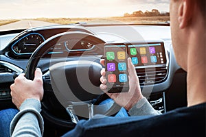 Car driver use smart phone with smart car app and use connection with car infotainment system