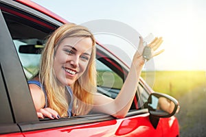 Car driver woman smiling showing new car keys and car.