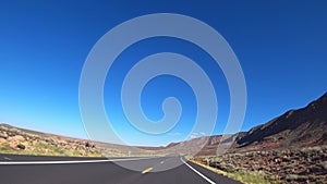 A car drives along a beautiful scenic road in California, USA.