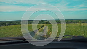 The car is driving along a country road nature .man driving a car on nature view from lifestyle the window hills summer