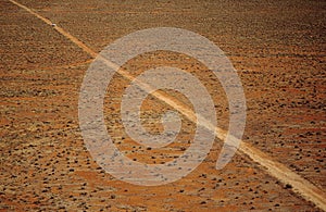 Car driving along desert road outback Australia