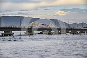 Car driving on bridge over the lake