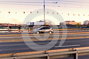 Car driving on a bridge road in the city, in motion with blurred background