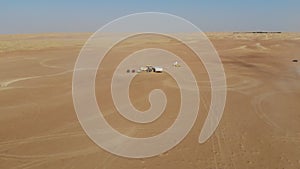 Car is driving in the desert. Dubai, drone camera