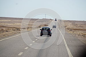 Car driving on desert road