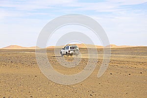 Car driving in the Erg Chebbi desert in Morocco