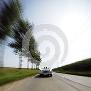 Car driving fast down road