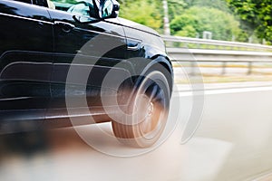 Car driving fast on highway motion blur