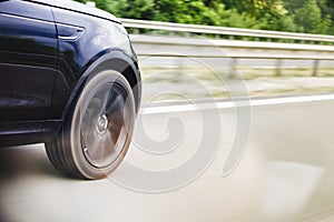 Car driving fast on highway motion blur