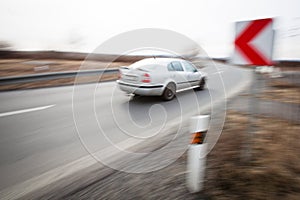 Car driving fast through a sharp turn