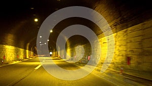 Car driving fast in tunnel at night