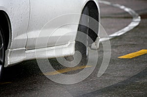 Car driving fast under the rain