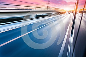 Car driving on freeway at sunset, motion blur