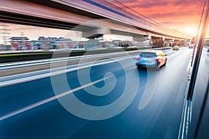 Car driving on freeway at sunset, motion blur