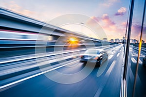 Car driving on freeway at sunset, motion blur