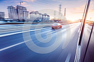 Car driving on freeway at sunset, motion blur