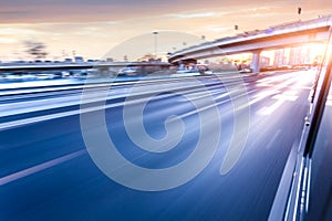 Car driving on freeway at sunset, motion blur