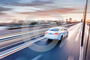 Car driving on freeway at sunset, motion blur