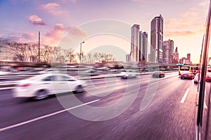 Car driving on freeway at sunset, motion blur