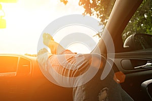 Car driving. Fun driver ride vehicle on road in travel trip. Happy young woman inside car on sunset in summer vacation