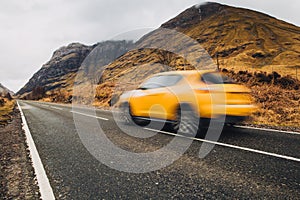 Car driving through Glencoe, Scotland. Scottish Highlands.