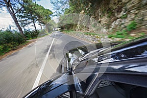 Car driving at high speed in mountain road