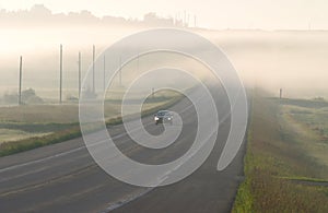 Car driving through the mist