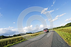 Car driving on a narrow country road