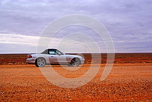 Car driving over desert photo