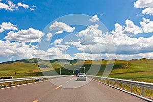 Car driving on the prairie path