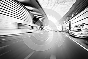 Car driving on road in city background, motion blur