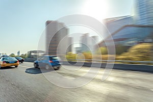 Car driving on road, motion blur