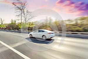 Car driving on road, motion blur