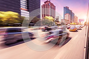 Car driving on road at sunset, motion blur