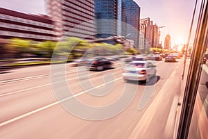 Car driving on road at sunset, motion blur