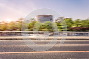 Car driving on road at sunset, motion blur