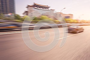 Car driving on road at sunset, motion blur