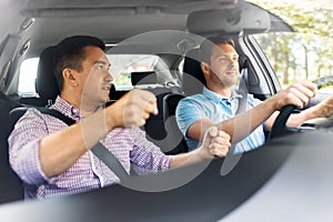 Car driving school instructor teaching male driver