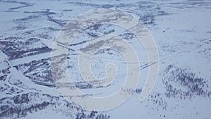 Car driving on snowy road far north landscape