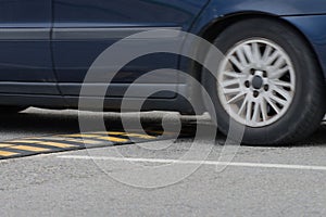 Car driving through a speed bump close-up