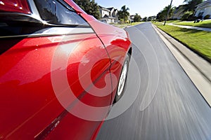 Car Driving at Speed on Suburban Street