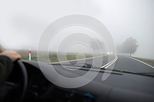 Car driving in thick fog