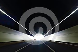 Car driving in tunnel exit