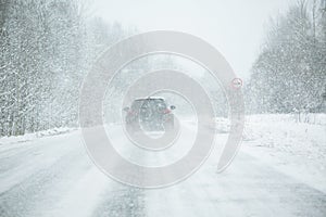 The car is driving on a winter road