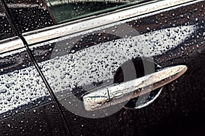 Car in drops of water after rain