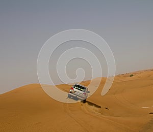 A car dune bashing in a desert in Dubai, UAE