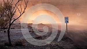 car on a dusty unsealed road in sunset light mood