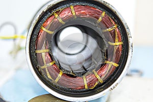 Car dynamo is awaiting repair for reuse as a source of energy in the car. Is a circle surrounded by copper, a source of electric