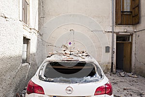 Car in earthquake rubble, Rieti Emergency Camp, Amatrice, Italy photo