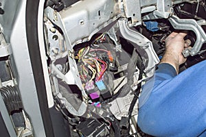 Car electrician checks the wiring of the car